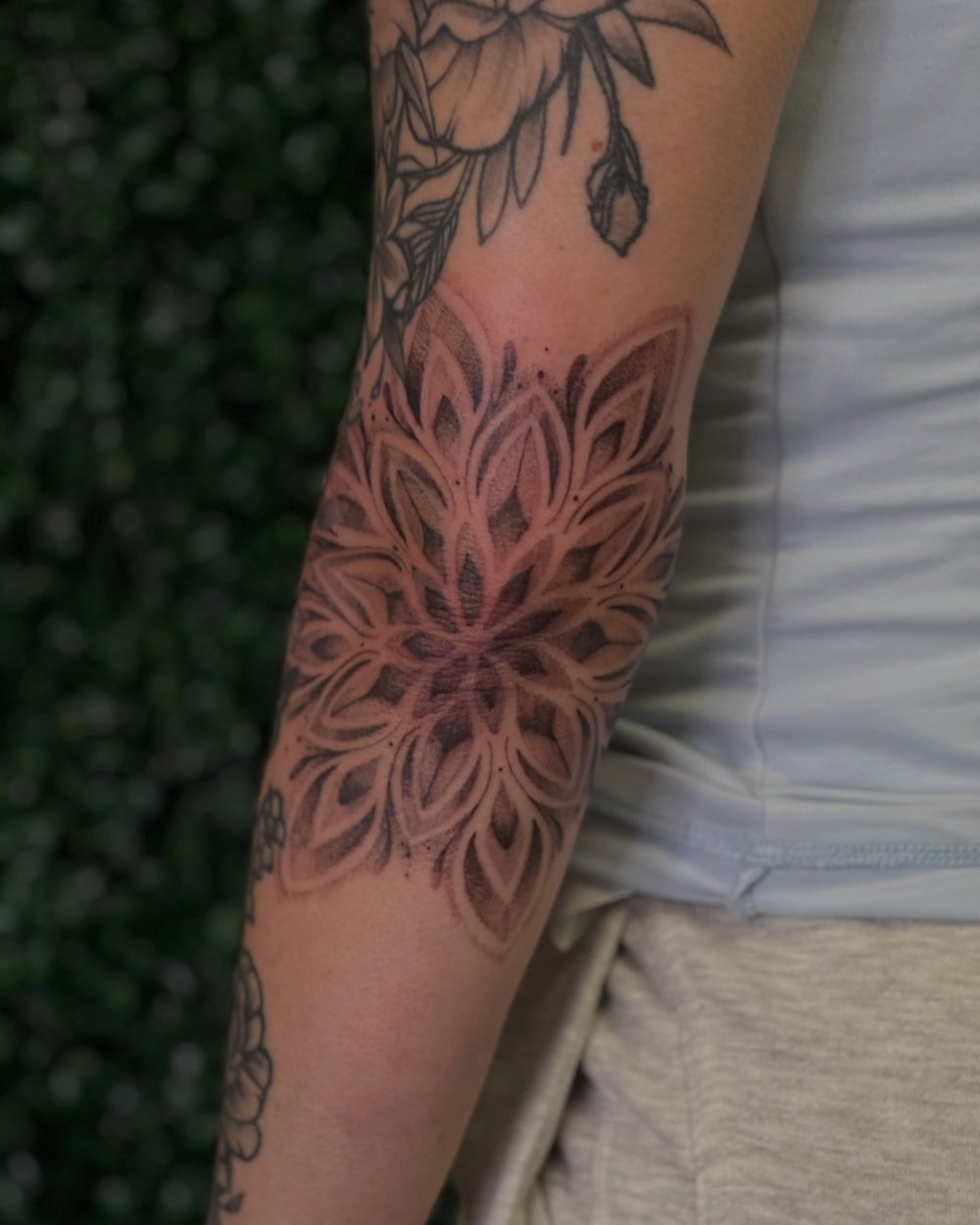 Dotwork mandala with peony on the arm